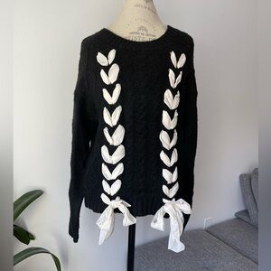Black and white cable knit sweater with white ribbon